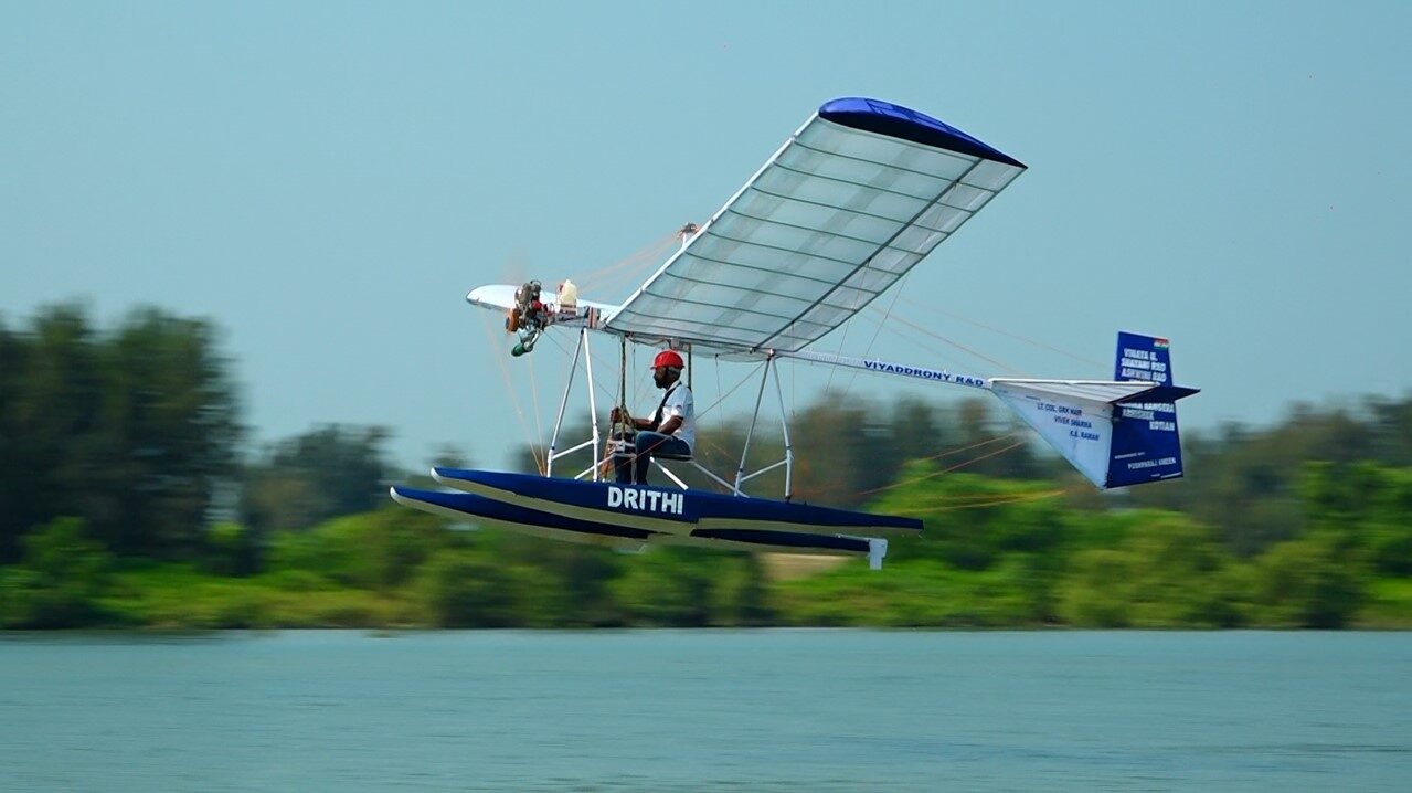 "India’s first indigenous single-seater microlight seaplane, DRITHI, developed by Viyaddrony R&D, in flight over water."